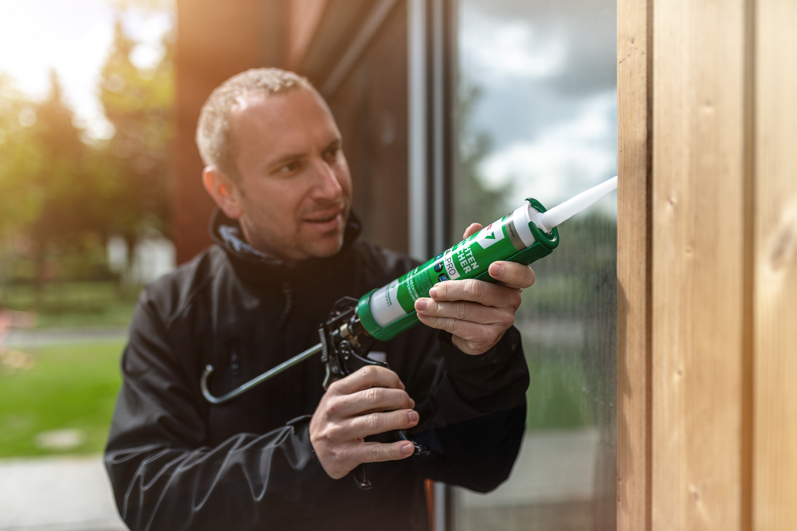 man sealing a window with x-seal